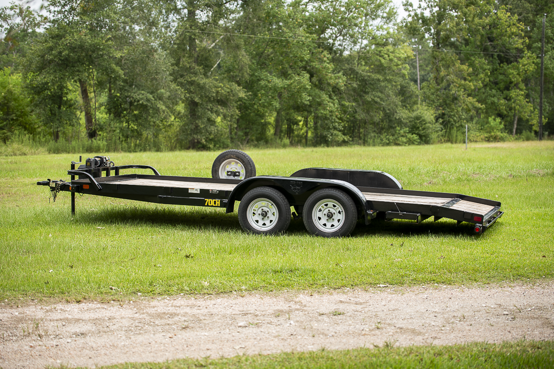 Side view of 18ft car hauler showing dual axle and spare tire mount
