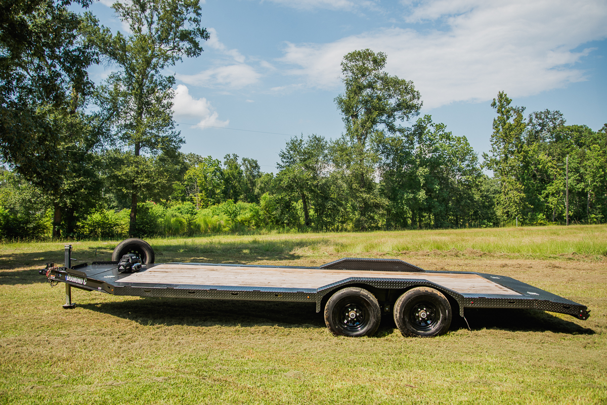 Flatbed car hauler trailer rental in a field